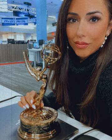 Sonia Azad and her Emmy Award. 